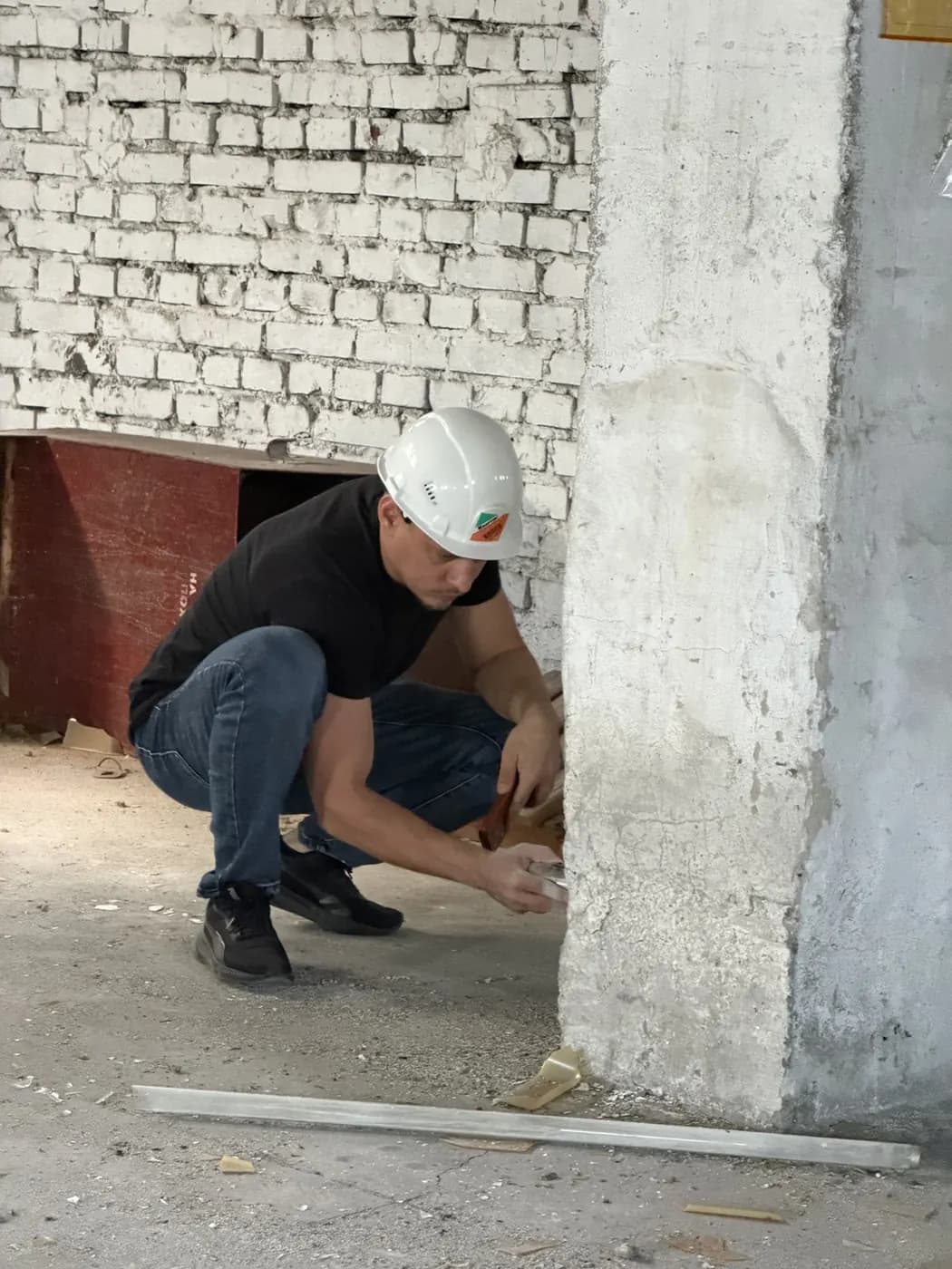 Осмотр основания железобетонной колонны у кирпичной стены